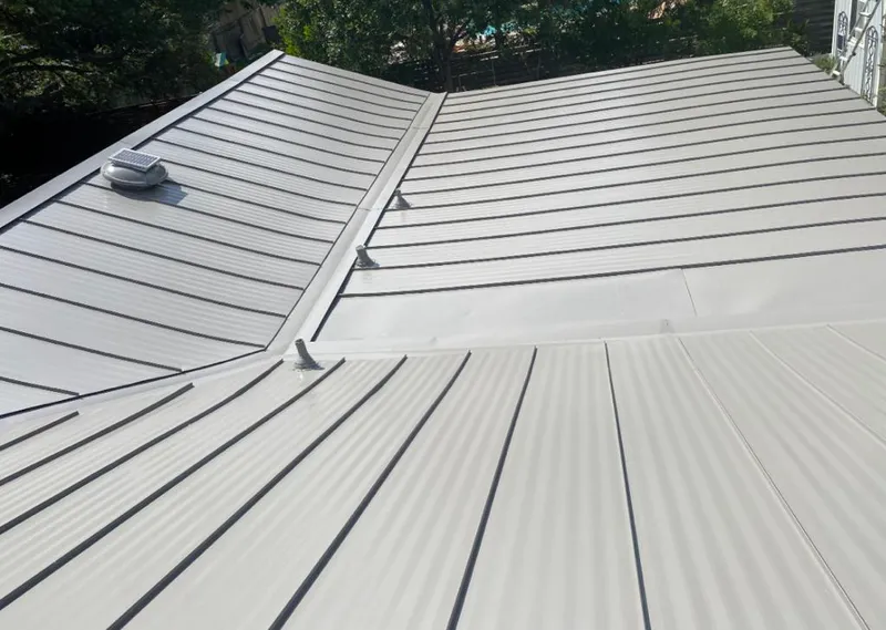 Solar attic fan installed on a metal roof for Roof Ventilation in Franklin